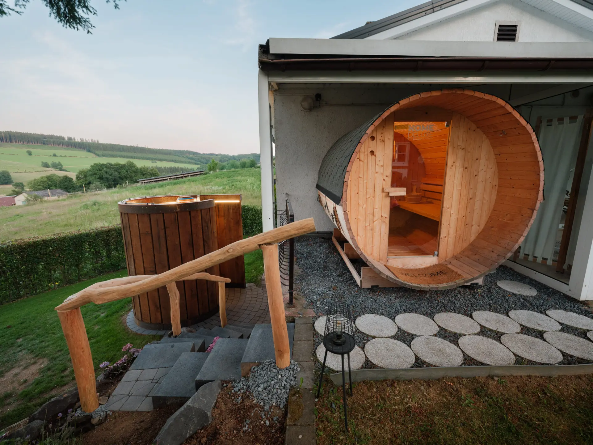 Sauna with outdoor shower and drench bucket